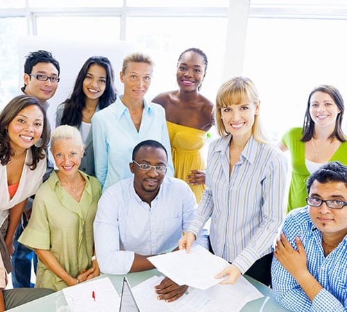 A group of people standing around each other.