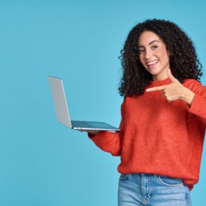 A woman in red sweater holding a laptop.