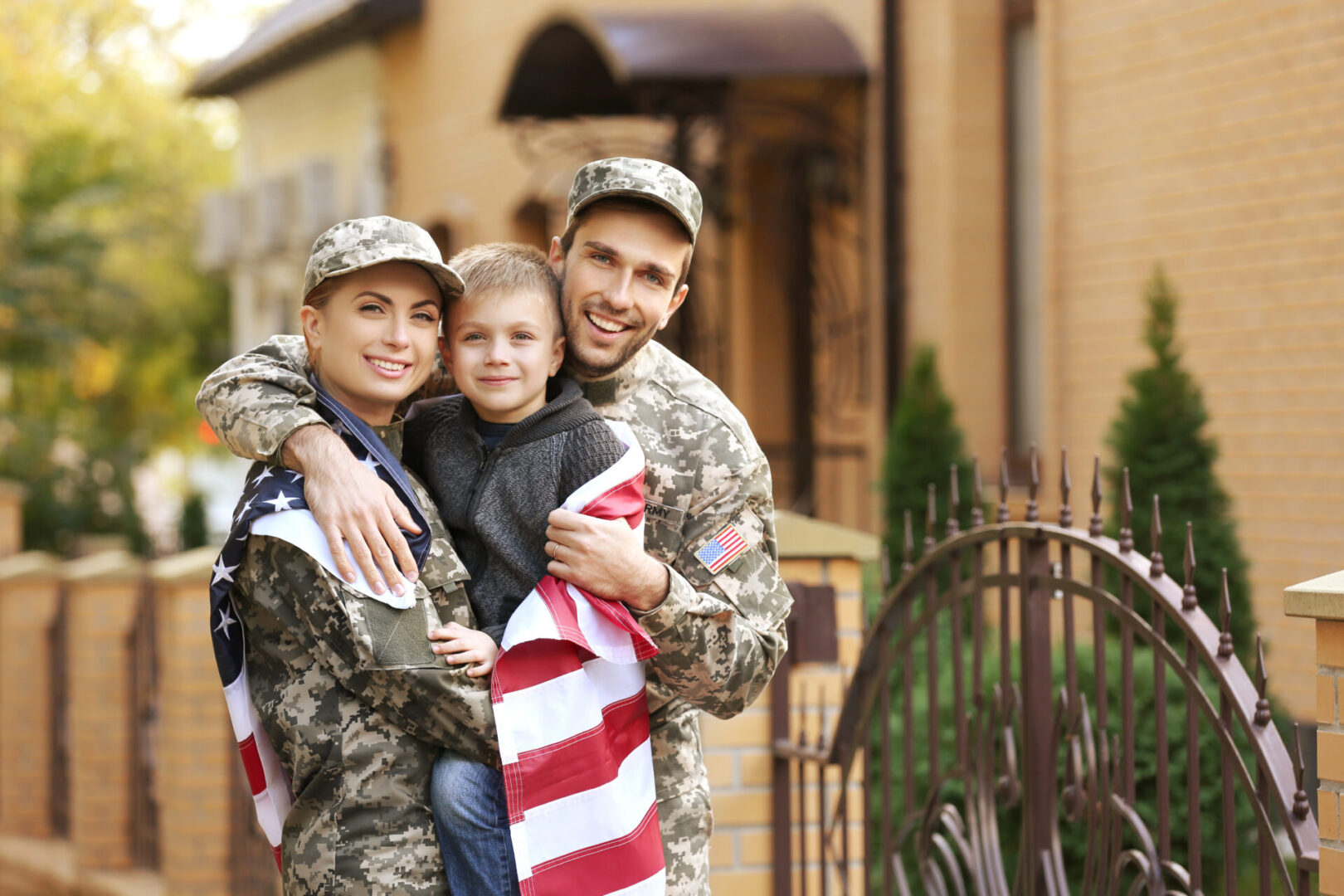 A couple of men and a child in military uniforms.